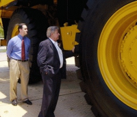 Ralph Klein tests the tires on a new Caterpillar 777F off-road truck in front of the Smithsonian building in Washington, D.C. Photo: Washington Post, via Sqwalk.com.