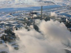 Steam rises from oilsands refineries in winter. 