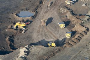 Trucks haul earth in an arial shot of an oilsands operation in Northern Alberta.  