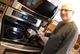 * David Dodge with his induction stove. These are far more energy efficient than a standard stove and you're actually cooking your food with an electromagnet.