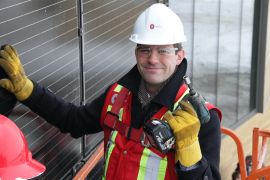 * Don Iveson, the mayor of Edmonton, prepares to screw in the last of 700 solar panels at a media event held to mark the opening of the Mosaic Centre. Photo by David Dodge Green Energy Futures