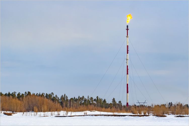 Methane flaring on a high pipe in winter