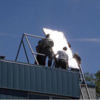 People installing solar panels for solar water heater