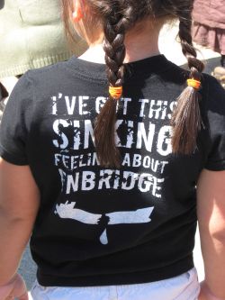 A young girl wears a T-shirt carrying the message: "I've got this sinking feeling about Enbridge."