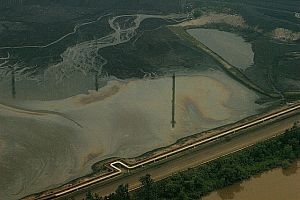 Flare stack reflected in oilsands tailings pond, 2013.