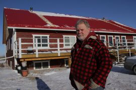 * Brent Kreuger in front of his home in Craik Eco-Village. Brent and his partner Monica were the first to overwinter in the Craik Eco-Village where they built their Praxis International Institute boarding school and home.  Their lot cost a dollar to purchase. Photo David Dodge, Green Energy Futures 