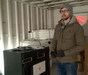 * Michael Nemeth with the 93% efficient heat recovery ventilator. Photo David Dodge, GreenEnergyFutures.ca