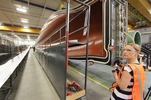 *Laura Heidbeuchel stands next to a 55-,metre long mold for wind turbine blades at Siemens' wind blade plant in Tillsonburg, Ontario. Photo David Dodge, GreenEnergyFutures.ca