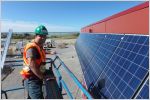 Solar installation in Behchoko with worker