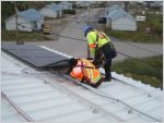 Workers installing solar panels in Kuujjuaq Quebec 