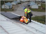 Workers installing solar panels in Kuujjuaq Quebec