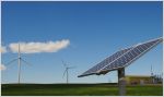 Wind turbines and solar panel in open field