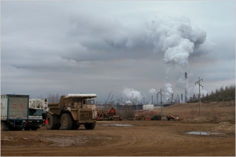 Oilsands facilities in Alberta - large trucks with cloudy sky