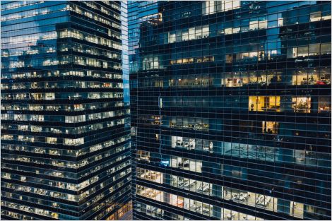 Nighttime scene of downtown skyscrapers with several empty offices (lights off)