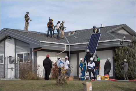 Group installing solar panels in central Alberta