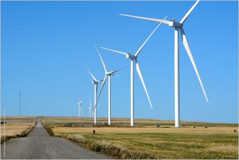 Zeroing In: affordable net-zero grid in Alberta cover with wind turbines and road