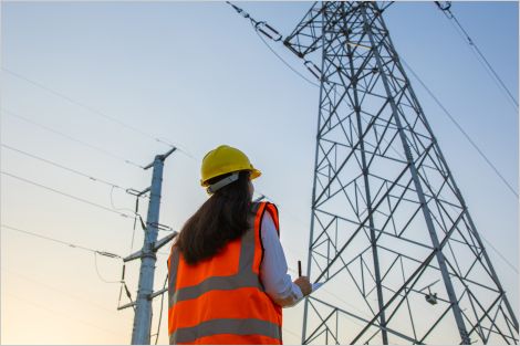 woman looking at electricity pylons