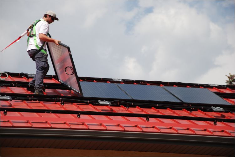 Solar PV installer works on roof
