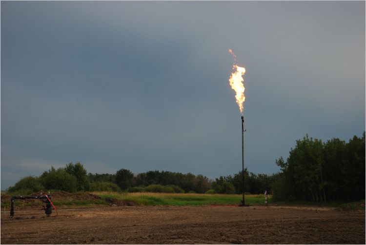 Methane flare in field at twiiight