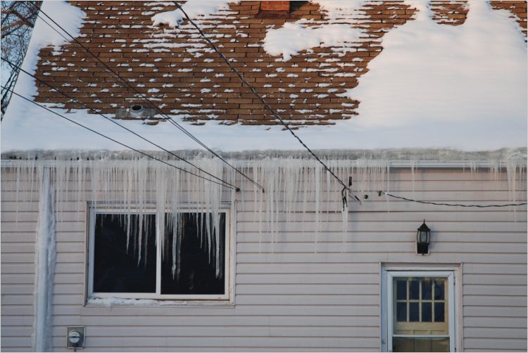 Icicles on roof edge of older house