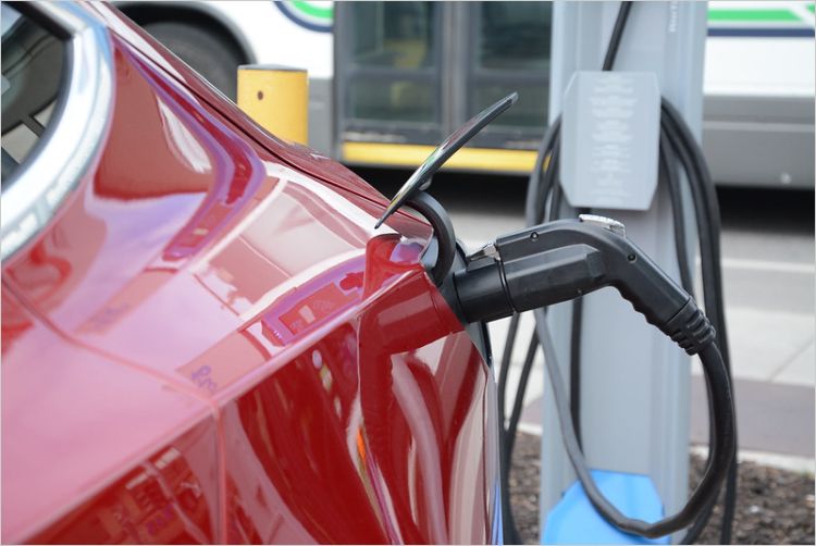 Red electric car at a charger