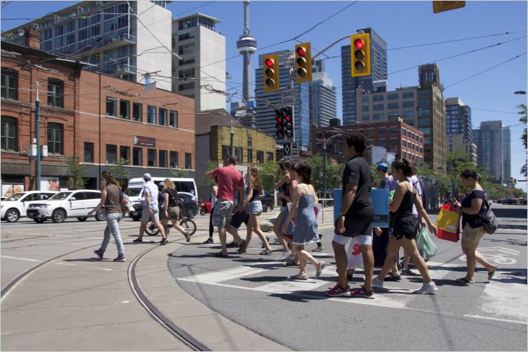 Pedestrians crossing busy Toronto street