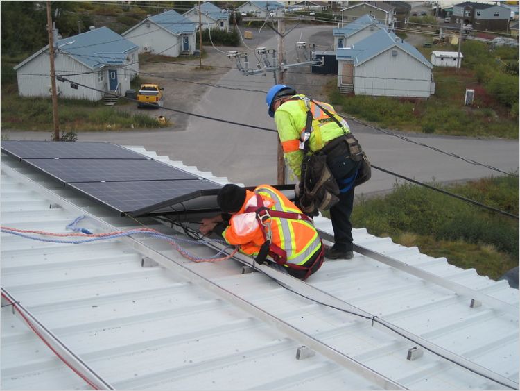 Workers installing solar panels in Kuujjuaq Quebec 