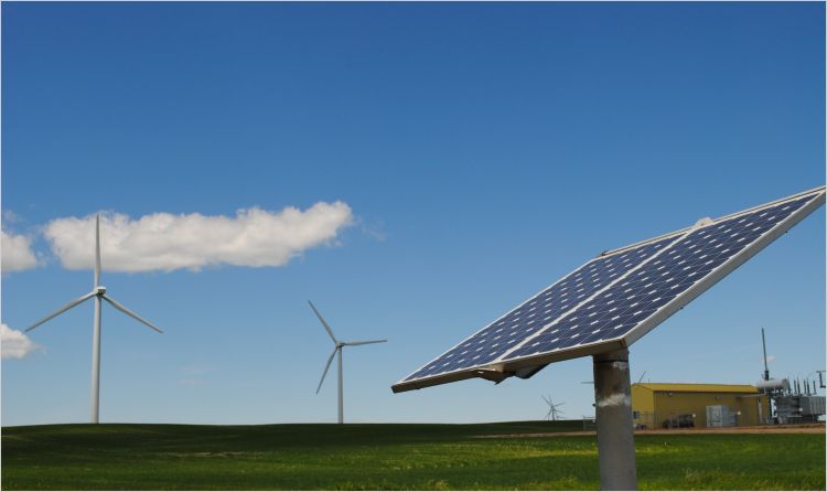 Wind turbines and solar panel in open field