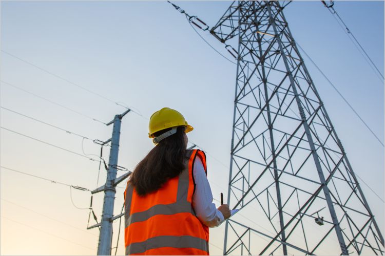woman looking at electricity pylons