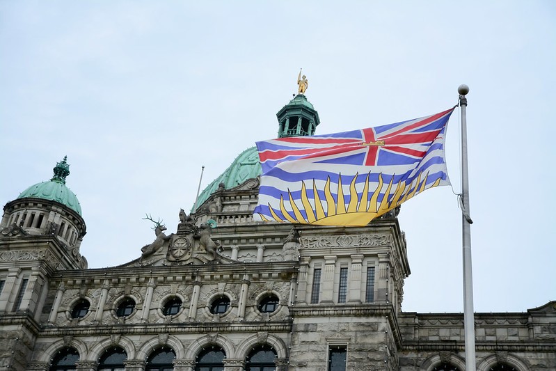 British Columbia legislature building in Victoria, B.C. with flag