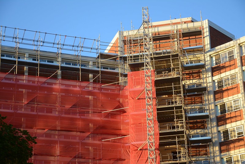 Multi-unit apartment building undergoing external retrofits