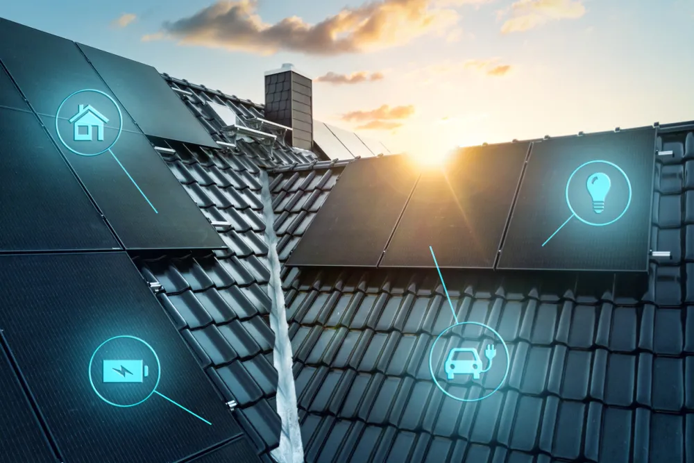 A modern smart home roof with dark solar panels at sunset