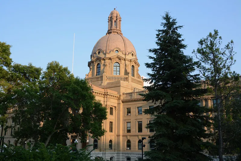 The Alberta legislature building with trees in the foreground