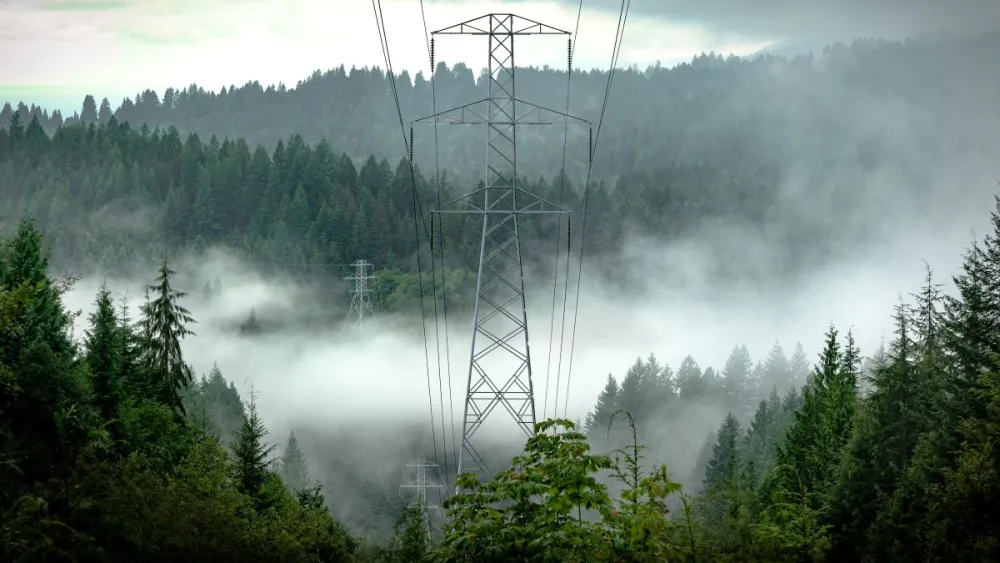 Mist in the BC mountains with electricity transmission line