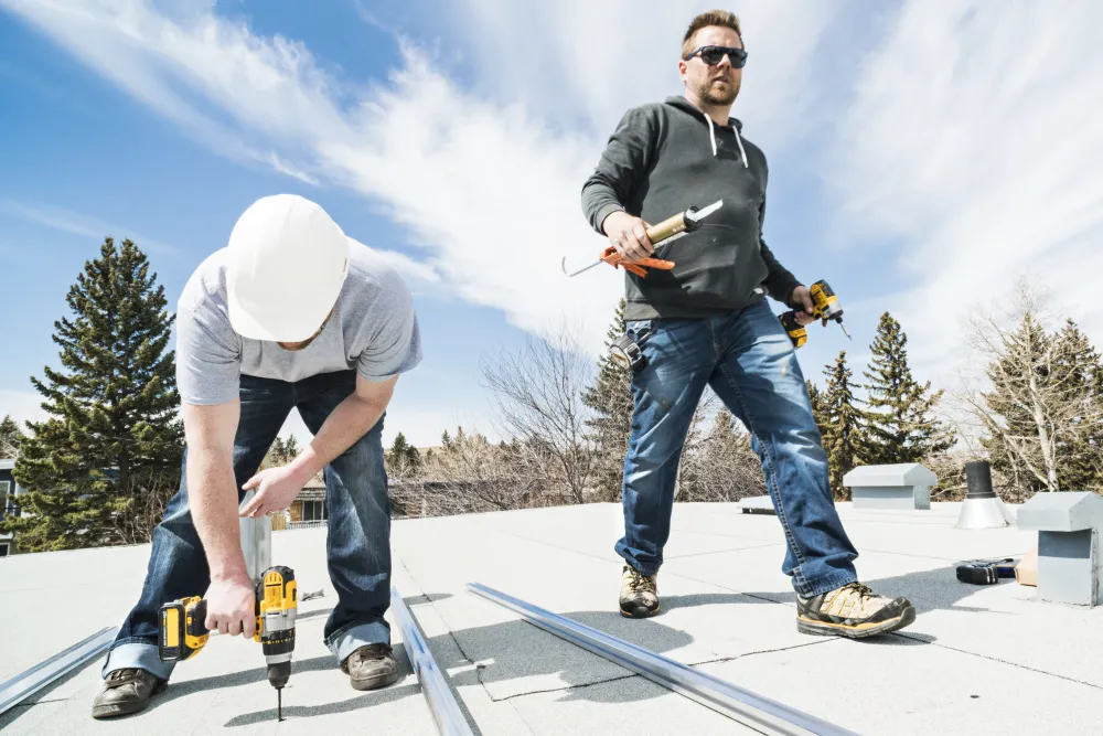 Workers installing racking and support for solar panels on a residential homes roof