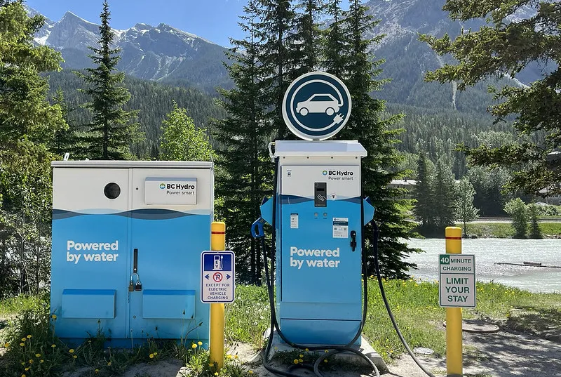 BC Hydro electric vehicle chargers with trees and mountains in the background