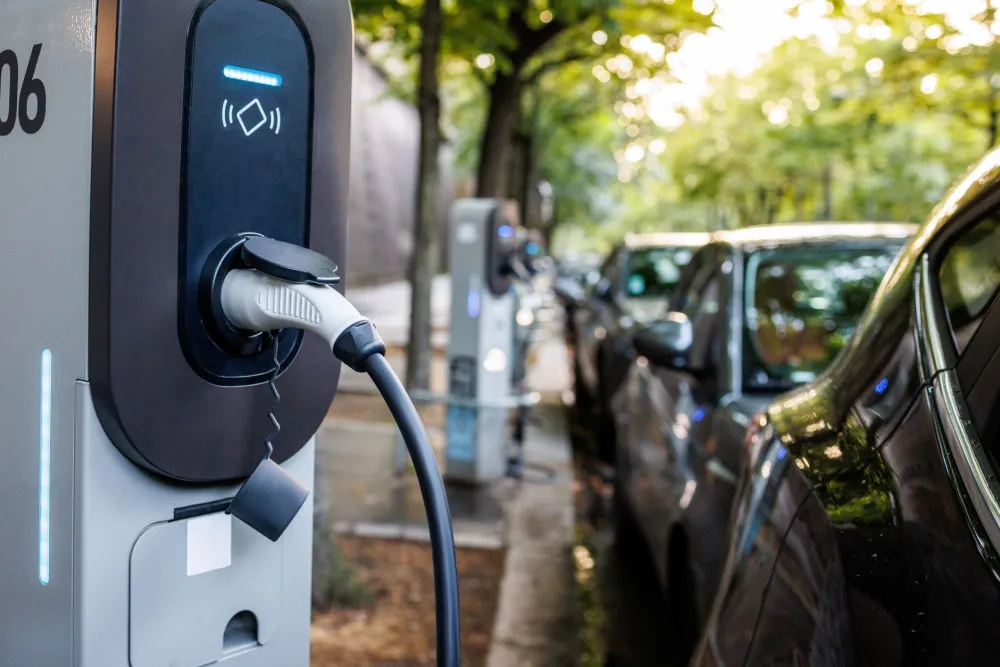 Close up of electric vehicle plugged into charger