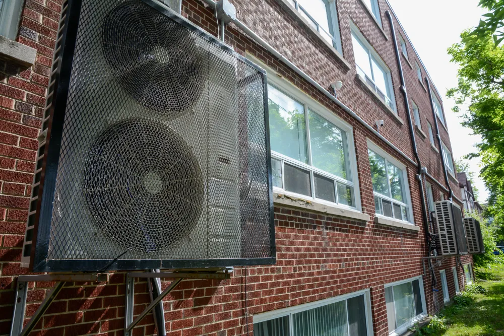 Heat pump installed at multiunit brick apartment building in Ottawa