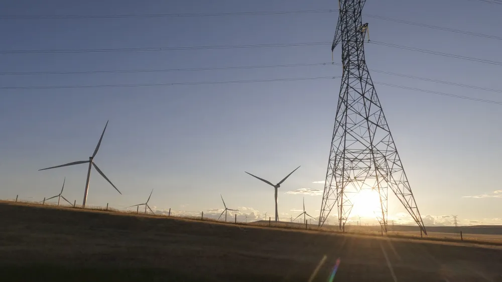 Scenic view of wind turbines and grasslands at sunrise, Pincher Creek, Alberta
