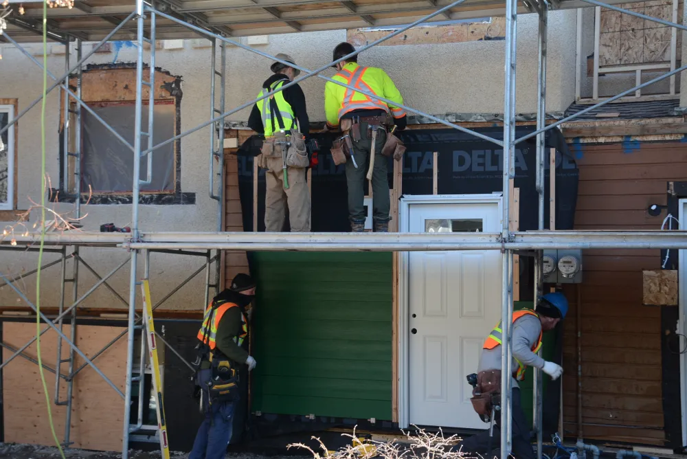 Construction workers working on an exterior retrofit