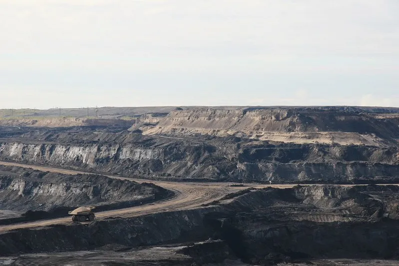 An oil sands mine with truck in foreground