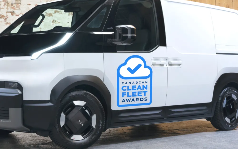 Close-up of a Kia PV5 van featuring the Clean Fleet Awards certified logo.