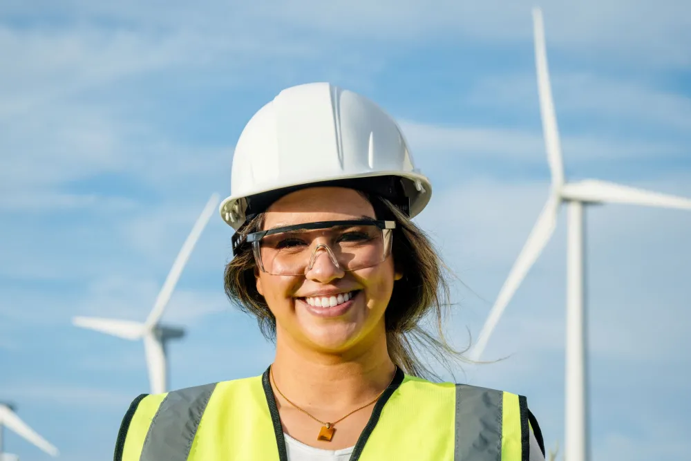 Adult woman engineer works at a wind farm