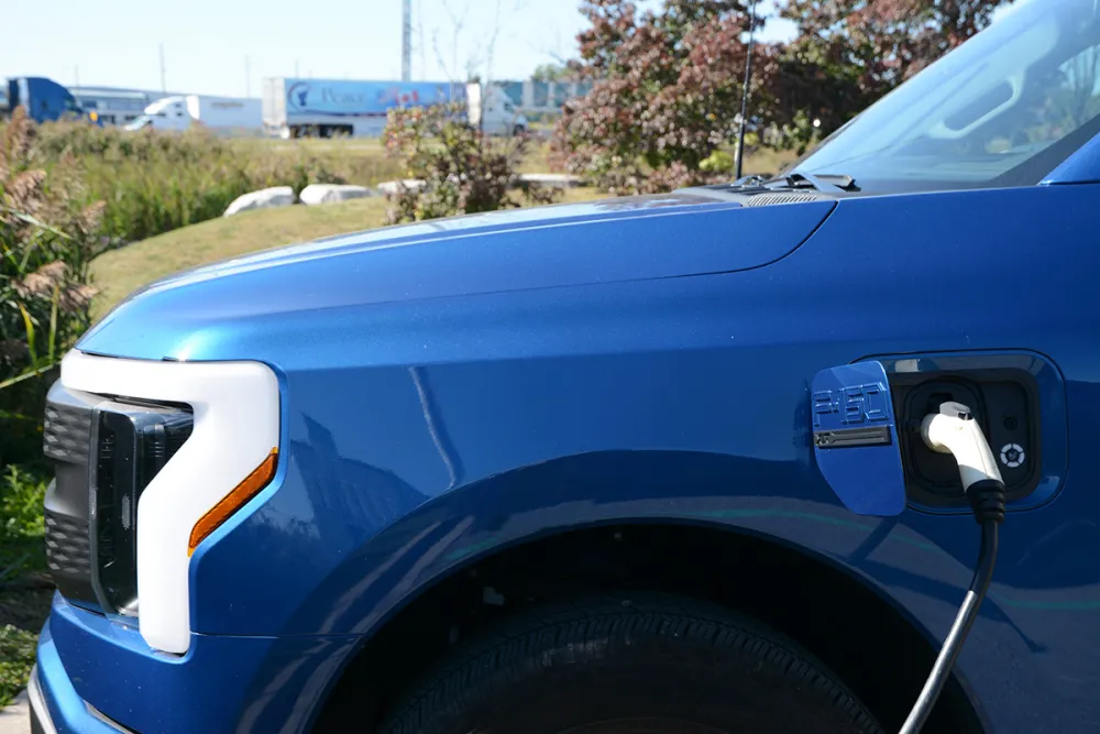 Electric pickup truck next to highway