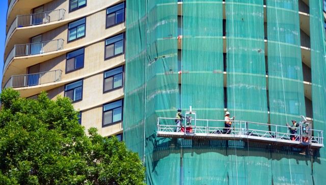 Workers on scaffold on apartment building