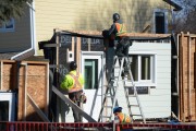 Men working with retrofit panels on a building construction site. 
