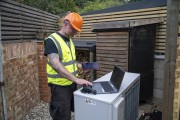 Service staff checking air source heat pump