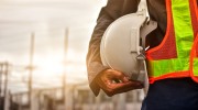 A close up of a technician holding a hard hat
